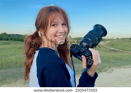 Happy woman is a professional photographer with dslr camera, outdoor and sunlight, Portrait.