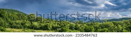 Panoramic view of the Carpathian mountains with beautiful storm clouds, Ukraine Royalty-Free Stock Photo #2335484763