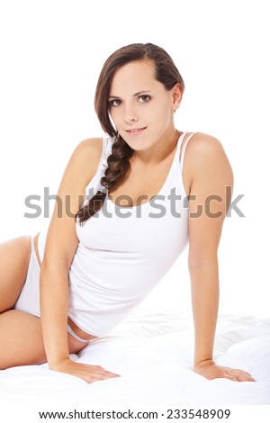 Attractive young woman in white underwear. All on white background.