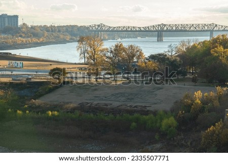 Mud Island River Park with Memphis Sign and Harahan Bridge over Mississippi River as seen from  Memphis Suspension Railway footbridge on sunset in Memphis Tennessee  