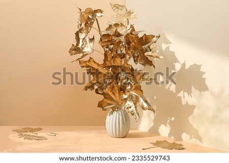 Creative autumn composition with golden maple leaves on premium pastel background for product showcase, minimal autumn concept, screen banner with space for text. Happy Thanksgiving  Royalty-Free Stock Photo #2335529743