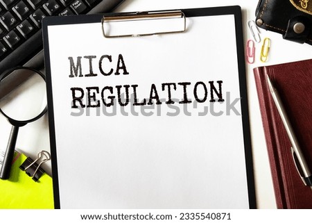 MiCA or Markets in Crypto Assets concept. Stacked cryptocurrency coins and wooden blocks with text. Copy space Royalty-Free Stock Photo #2335540871