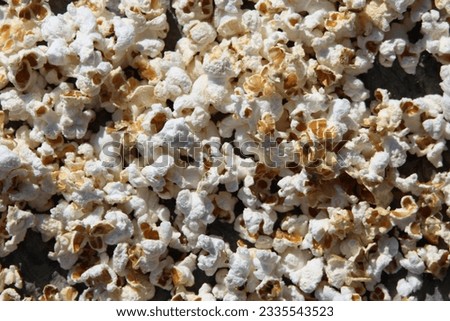 Some popcorn on a rock background. Perfect for news and articles about corn. High quality photo