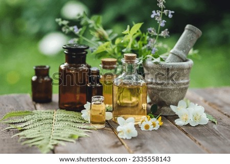 Assortment of pure organic natural essential aroma oil with mint , camomile on wooden background. Concept of herbal, floral ingredients in cosmetology. Alternative medicine, therapy, Ayurveda Royalty-Free Stock Photo #2335558143