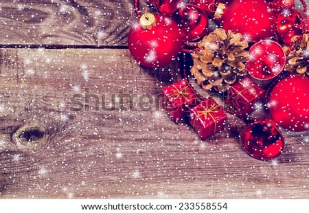 Christmas card with snow, stars, fir and decor on wood background