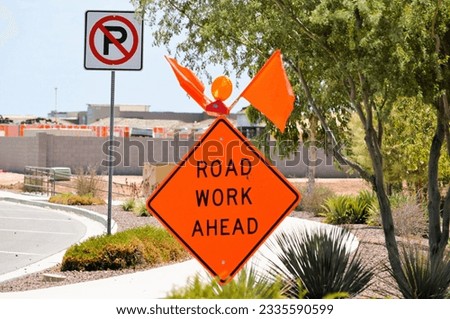 road work ahead street sign and flags - maricopa arizona new housing development