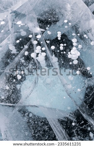 Gas methane bubbles frozen in blue ice of lake Baikal, Siberia, Russia