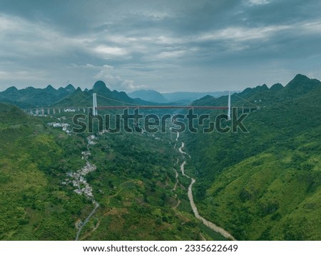 Aerial photography of the Balin River Bridge and surrounding homestays and landscapes in Anshun, Guizhou, China.