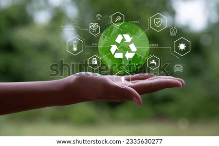 Earth handshake and icon of reuse Reduce recycling and waste in a zero waste concept and stewardship. Save and circulate for environmental sustainability. The concept saves the world blurred backgrond Royalty-Free Stock Photo #2335630277
