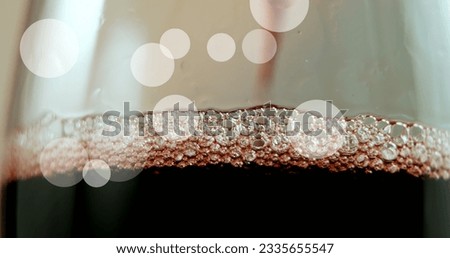 Composite of white spots of light over red wine in glass. Alcohol and drink concept digitally generated image.