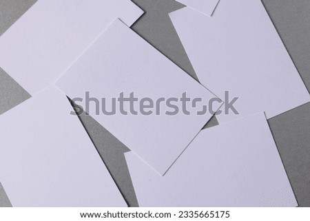 White business cards with copy space on grey background. Business, business card, stationery and writing space digitally generated image.