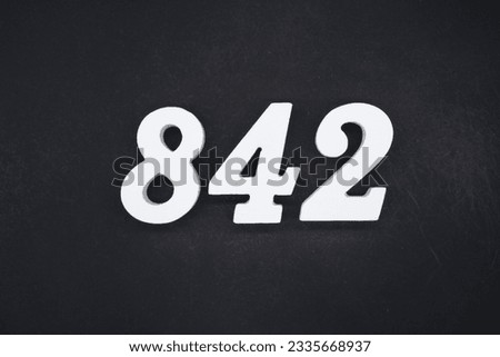 Black for the background. The number 842 is made of white painted wood.