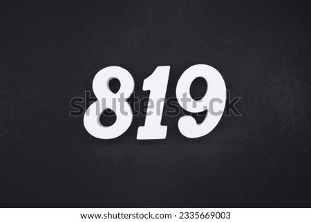 Black for the background. The number 819 is made of white painted wood.