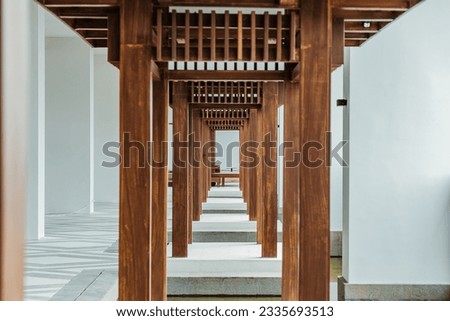 Wooden Architectural Column in Daylight. Japanese pole wooden style. Architectural Column in Natural Wood Structure. Japanese elegant wooden architectural. Empty space, no people. Royalty-Free Stock Photo #2335693513