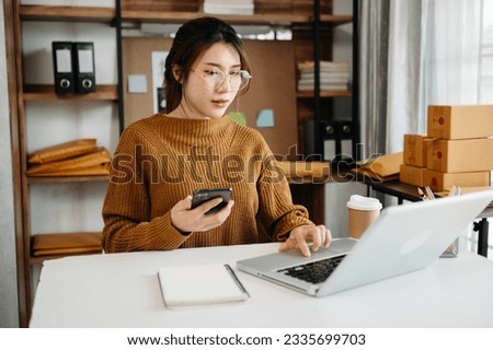 Woman using laptop, smartphone, tablet and writing on the notepad at office of her business online shopping. In home 
