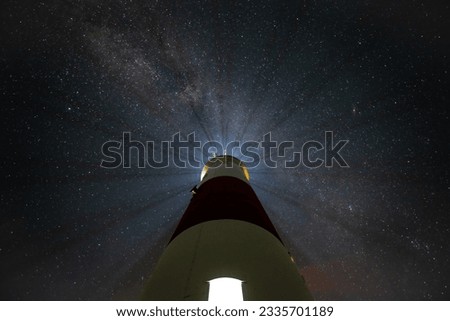 Lighthouse Astrophotography background looking from below milky way  Royalty-Free Stock Photo #2335701189