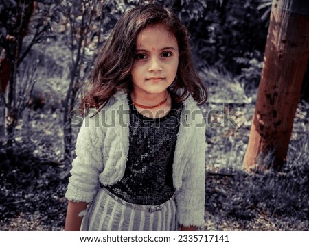 Present filter effect on camera portrait photo. Little kid girl playing outdoor in park. Healthy baby vintage photo of light and dark effect. Amazing style looks Glorious.  