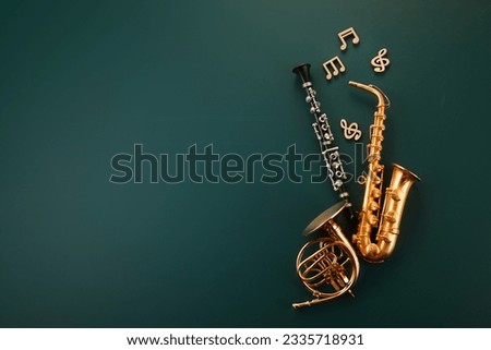 Music lesson school education concept. Wind instruments on green chalkboard. Royalty-Free Stock Photo #2335718931