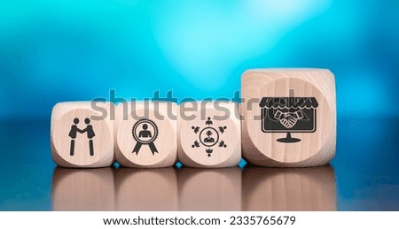 Wooden blocks with symbol of customer loyalty concept on blue background