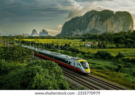A beautiful scene in the morning with the background of rice fields and trains. Location Perlis Malaysia. Royalty-Free Stock Photo #2335770979