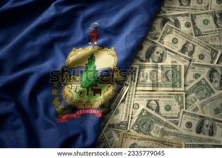 big colorful waving national flag of vermont state on a american dollar money background. finance concept