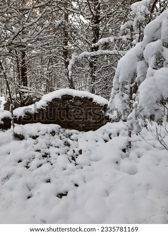 Snow builds up this once strong wall. Royalty-Free Stock Photo #2335781169