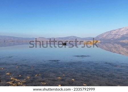 Civril, Denizli, Türkiye; Illuminated Lake view, wooden fishing boats, drought problem, global warming.