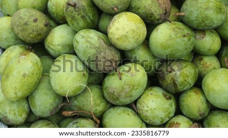 mango fruit with green skin and bright yellow flesh that is very fresh and sweet