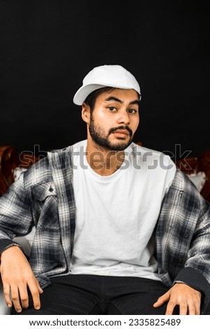 Expertly captured, the image features a man wearing a white blank shirt and hat, adding a touch of sophistication to your visual presentations
