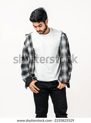 The mockup highlights a man donning a white shirt, elegantly arranged with a simple pose, perfect for your artwork