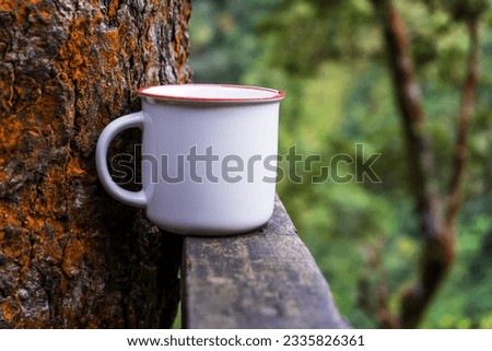Gracefully presented, the mockup captures the essence of a white blank mug arranged with simple style amidst the tranquility of nature