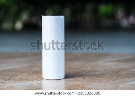 Professionally staged, the mockup showcases a white tumbler in a simple style, ideal for your branding efforts