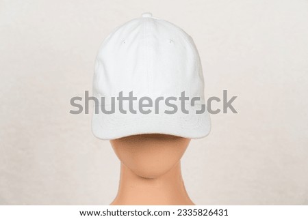 A visually appealing mockup image features a white blank hat, elegantly arranged with a simple and tidy style, captivating viewers with its charm