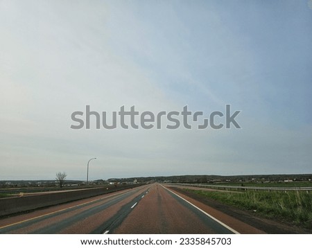 An open divided highway on a cloudy spring morning.