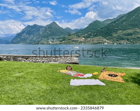 Spiagga pubblica Carzano on Monte Isola in Lago d'Iseo, Lombardy, Italy. Royalty-Free Stock Photo #2335846879