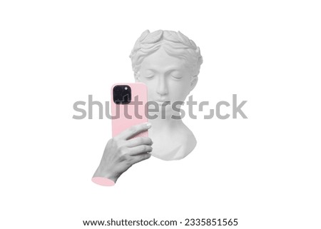 Antique female statue's head holding mobile phone with camera taking a picture or surfing Internet isolated on a white background. 3d trendy collage in magazine style. Modern design. Contemporary art
