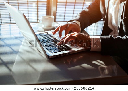 working on laptop, close up of hands of business man Royalty-Free Stock Photo #233586214