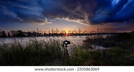Sunset over city and river with coming storm from side. Landscape nature picture