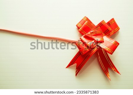Red ribbon bow on paper background - Vintage filter effect processing style pictures