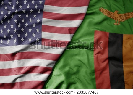 big waving colorful flag of united states of america and national flag of zambia . macro