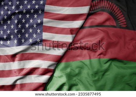 big waving colorful flag of united states of america and national flag of malawi . macro