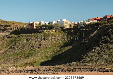 View of colourful houses in Las Coloradas neighbourhood on top of hill in La Isleta, Las Palmas de Gran Canaria, Spain