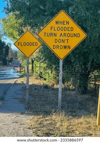 Flooded and when flooded turn around don't drown signs on the side of the road.