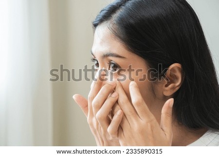Ophthalmology care, eye sight or vision. Closeup asian young woman, female hand holding and putting, wearing soft contact lens on face with finger, look into eye on background. Medicine and health. Royalty-Free Stock Photo #2335890315