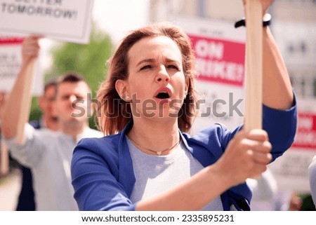 Workers Strike Demonstration In City. Labor Union March. Protest Rally Royalty-Free Stock Photo #2335895231