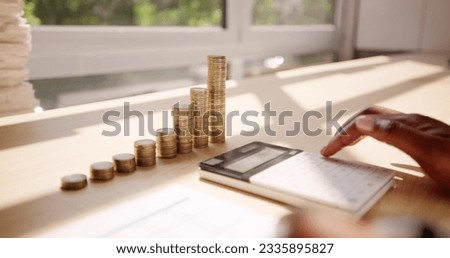 Accountant Calculating Tax Using Calculator On Desk. Save Money Concept