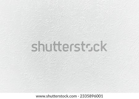 A wall with patterned textured plaster