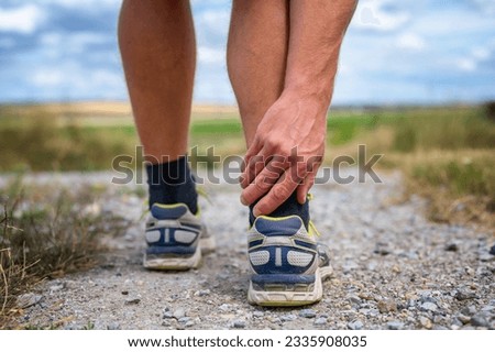 Pain of a jogger at the Achilles tendon Royalty-Free Stock Photo #2335908035