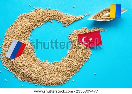 Ukrainian ship grain wheat, Turkey and Russia flags background. Grain deal and problem of blockade of ports, grain corridor, Ukraine Russia conflict. Royalty-Free Stock Photo #2335909477