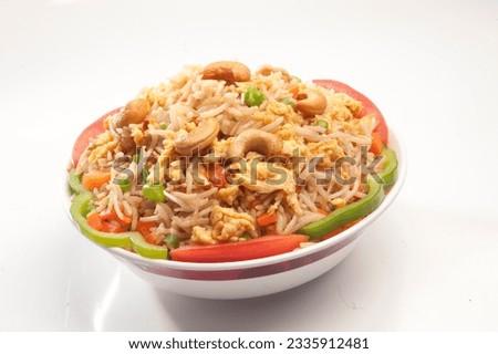 Egg fried rice with cashew nut. Is a popular Chinese-Japanese delicacy all over Japanese. Arabic, Chinese cuisine pictures, isolated on White background.